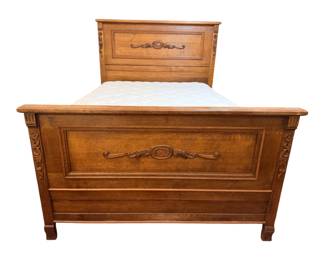 antique Victorian Eastlake carved oak full-size bed featuring ornate raised panels and detailed scrollwork carvings