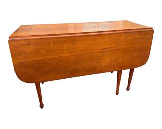 This is a beautiful pegged wooden drop-leaf table with turned and tapered legs and drawers on each end