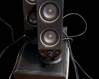 the classic Logitech X-230 2.1 speaker system, consisting of two dual-driver satellite towers and a ported subwoofer