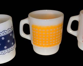 Anchor Hocking Fire King milk glass coffee mug featuring a mid-century red polka dot and lace pattern. And blue polka dot and lace pattern. The metal mug is Anchor hocking yellow kingdom made for fire king.