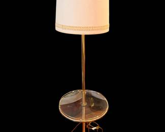 vintage Hollywood Regency brass floor lamp featuring an integrated glass shelf and a classic fabric drum shade