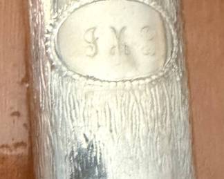 We all remember these! a silver-toned metal lighter sleeve holding a standard Bic pocket lighter, featuring an engraved oval monogram cartouche