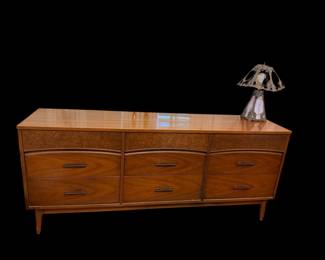 vintage mid-century modern dresser features a warm walnut finish and distinctive burl wood accent panels along the top drawers
