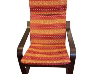 IKEA POÄNG armchair featuring a vibrant orange and red geometric kilim-patterned cushion cover