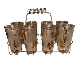 a vintage mid-century modern set of frosted highball glasses with a gold leaf pattern and a matching metal carrier, commonly known as the Libbey "Golden Foliage" Bar Set from the 1950s–1960s