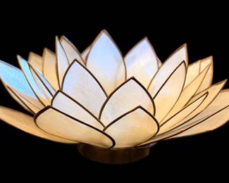 handcrafted lotus flower tealight and candle holder made from delicate, translucent capiz shells with dark soldered trim