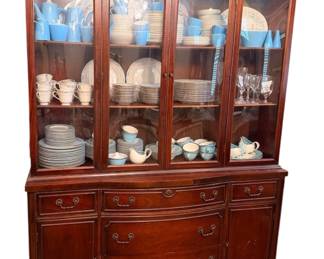 traditional two-piece wooden china cabinet and hutch with glass-paneled upper display doors and lower storage drawers and cabinets