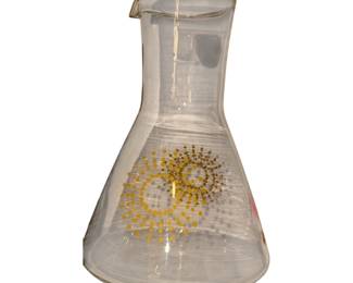 vintage Pyrex clear glass juice carafe or decanter featuring a mid-century atomic sunburst and dot pattern in gold