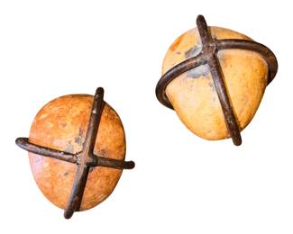 Handmade by folk artists and boutique metalworkers, these accents typically feature natural river stones or fieldstones tightly bound within a custom, hand-forged reclaimed iron or copper band shaped into a traditional cross. They are popular as tabletop sculptures, paperweights, or symbolic pedestal decorations
