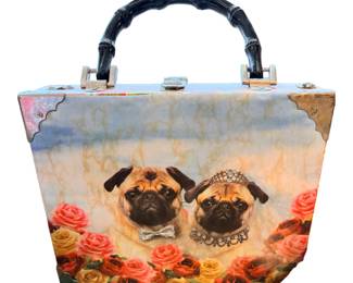 vintage-style novelty handbag features a whimsical portrait of two dressed-up pugs surrounded by colorful roses