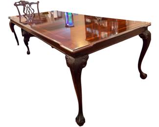 Thomasville, mahogany claw and ball formal dining table /This high-end piece is styled in a traditional Chippendale aesthetic. It features a flame mahogany wood top with a carved banded, apron, and cabriole legs ending in the ball and claw /there are 2 leaves