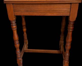 an antique wooden side table featuring a rectangular top, a single frieze drawer, and elaborately turned legs joined by stretchers.