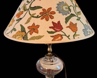 a vintage oil lamp that has been converted into an electric table lamp, topped with a detailed floral tapestry Shade