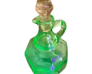 This is a vintage green uranium depression glass octagonal oil and vinegar cruet with a matching stopper.