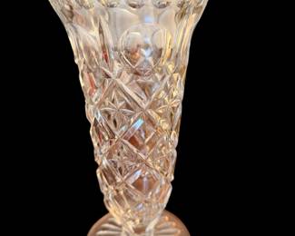 clear, vintage cut-lead crystal footed vase featuring a flared, scalloped rim, a diamond and fan cut pattern, and a starburst base