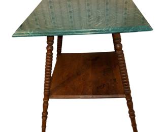 This is an antique oak two tier parlor table with a green replaced top