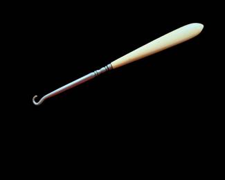 This is an antique shoe button hook with a French ivory celluloid handle. late Victorian to Edwardian era (circa 1890s–1920s)