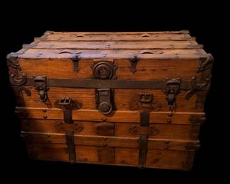 an antique wooden flat-top travel or steamer trunk, likely dating from the late 19th to early 20th century.
