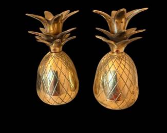 A pair of brass pineapple candle holders