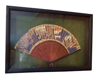 an antique 19th-century Chinese Canton export folding fan, often referred to as a "thousand faces" or Mandarin fan, featuring hand-painted gouache scenes on paper with inset painted faces and carved wooden or lacquered sticks, displayed in a shadow box frame