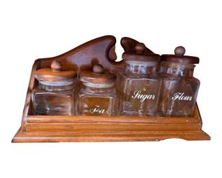 a vintage mid-century wooden and glass 4-piece canister set