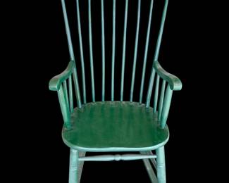 a vintage green wooden Windsor-style spindle-back rocking chair.