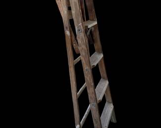 vintage wooden 4-step ladder with a rustic, weathered finish