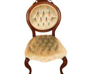 This is a vintage Victorian-style balloon back accent chair with carved rose details and tufted velvet upholstery.