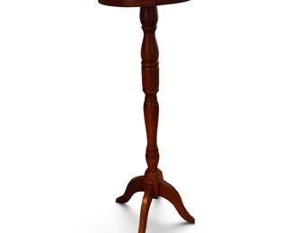 a traditional round wooden pedestal accent table or plant stand with a turned central column and three curved legs