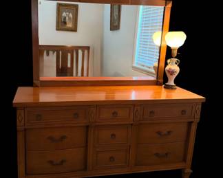 This is a vintage mid-century or transitional style dresser with mirror