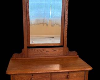 an antique American oak dresser with an adjustable mirror dating from the early 1900s.