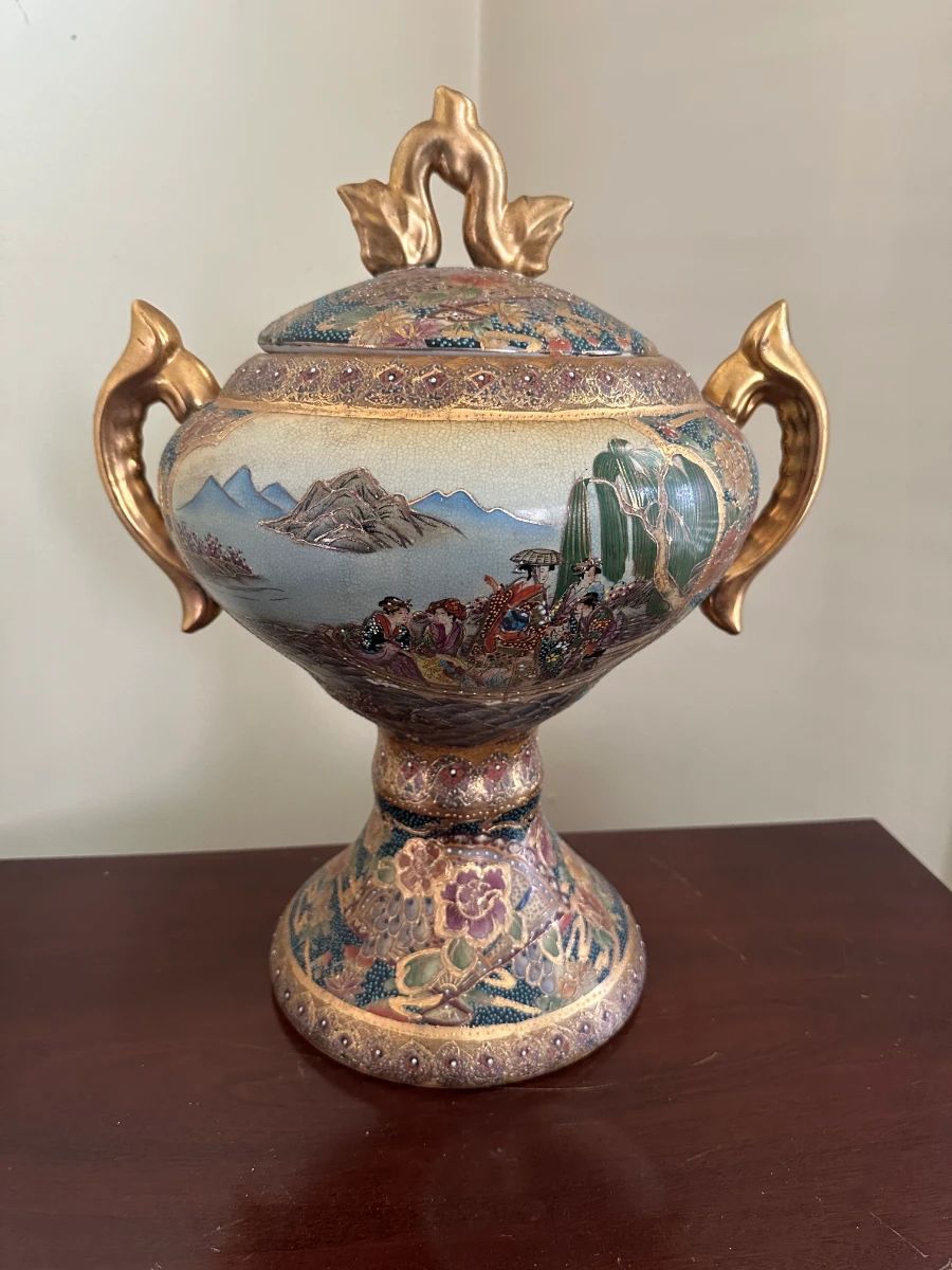 Vintage hand-painted decorative urn with gold leaf handles and scenic landscape detail