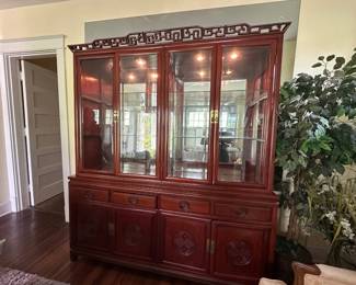 Cherry wood china cabinet with lighted glass display shelves and lower storage