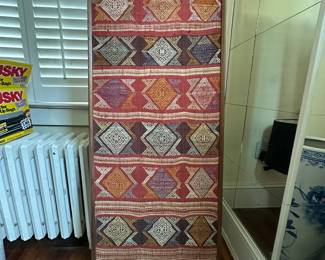 Handwoven area rug with colorful geometric diamond pattern