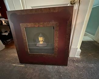 Decorative fireplace surround with Buddha figurine centerpiece
