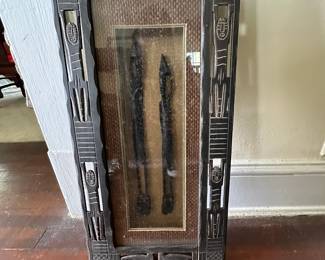 Carved wooden shadow box with African-inspired figures and geometric border