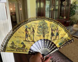 Ornate hand-painted folding fan with Egyptian motif and gilded frame