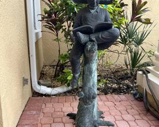 Boy Reading Book with Dog, 149lb Cast Bronze made using lost wax method and is 55 inches tall by Leonardo Rossi.