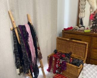 Scarves, Wraps & Fashion Accessories 🧣 A large assortment of scarves, wraps and textured accessories in everything from neutrals to bold colors and prints, plus jewelry, shoes and other fashion finds throughout the room. Also pictured is a beautiful wicker storage trunk.