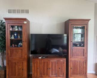 Living Room Furniture & Electronics 📺 Matching warm wood entertainment collection featuring two tall glass-front display cabinets/curio towers and coordinating TV console, plus a large flat-screen TV. Great storage and display pieces, with additional collectibles and décor throughout the sale.