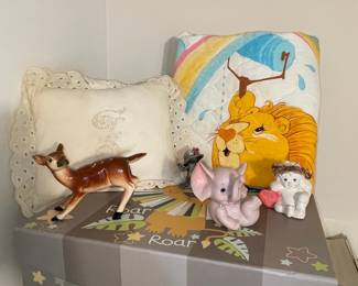 Vintage Nursery Decor: Ceramic Figurines and Safari-Themed Pillow