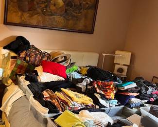 Bed is packed with clothes, neatly organized