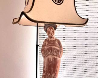 Clay figure on top of pedestal lamp