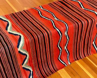 This lot features a stunning hand-woven Diné Navajo rug circa 1890-1900. Measures 63” x 51” and comes with fair market appraisal/condition report provided in photos.