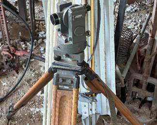 SURVEYOR TRANSIT ON TRIPOD + GRADE STICK AND TRIPOD