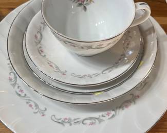 Rose-patterned fine china. 6 full place settings plus serving platter, bowl, salt and pepper shaker, cream pitcher, sugar bowl, and soup tureen.