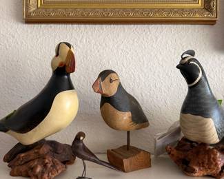 Carved puffins and various other birds