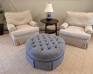 Pair of club chairs by Baker & tufted round ottoman