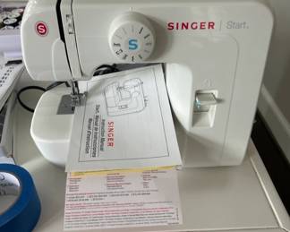 Various crafting supplies including a singer sewing machine