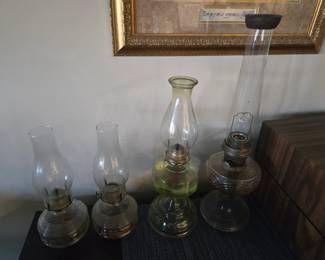 Antique hurricane lamps of various sizes